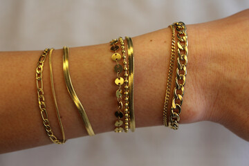 Photo of copper-gold yellow bracelets jewelry jewelry on the wrist photographed under white LED...