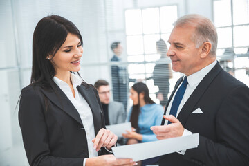 businessman and businesswoman discussing a business document