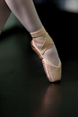 Ballerina's legs in close-up ballet shoes.