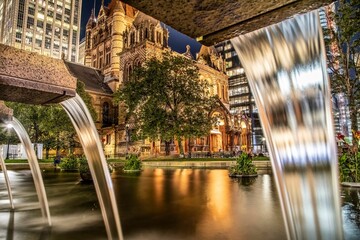 Street with the view of Trinity Church in the evening in New York.