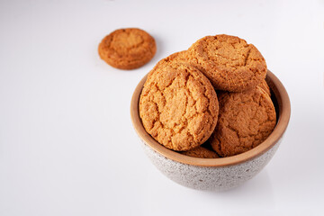 round oatmeal cookies lie in a gray ceramic bowl, copy space