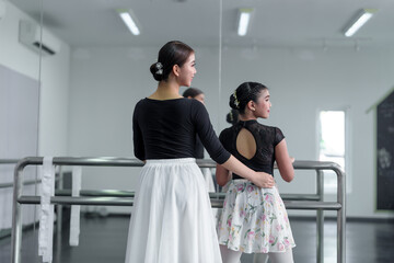 Fototapeta premium Female ballet dancers rehearse in ballet classes, they practice dancing, they are professional theater actors.