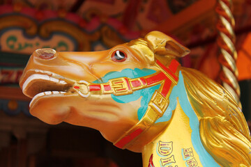 Fototapeta na wymiar The Wooden Head of a Fun Fair Carousel Horse.