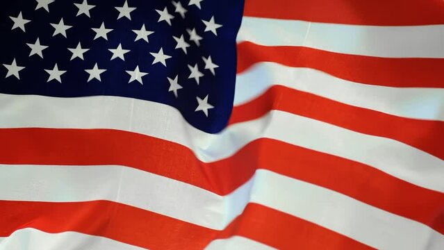 Video of American USA flag waving on the wind on black background.