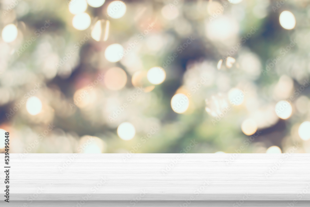 Wall mural empty wood table top with blur christmas tree with bokeh light background