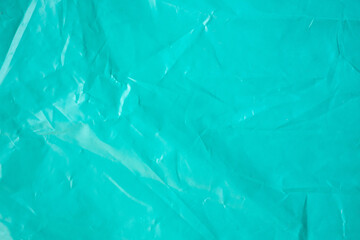 Blue wrinkled plastic bag texture background close up