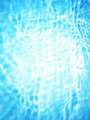 Defocus blurred transparent blue colored clear calm water surface texture with splashes and bubbles. Trendy abstract nature background. Water waves in sunlight with copy space. Blue watercolor shining