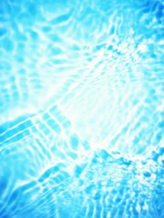Defocus blurred transparent blue colored clear calm water surface texture with splashes and bubbles. Trendy abstract nature background. Water waves in sunlight with copy space. Blue watercolor shining