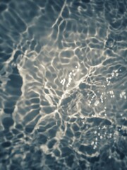 Defocus blurred transparent blue colored clear calm water surface texture with splashes and bubbles. Trendy abstract nature background. Water waves in sunlight with copy space. Blue watercolor shining