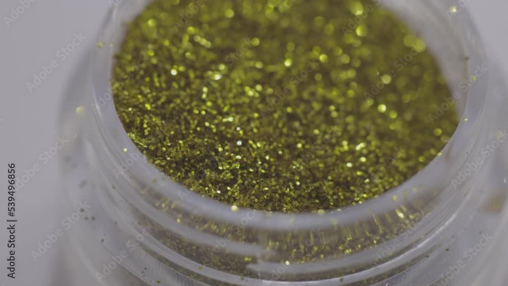 Poster golden sequins in a jar rotate in a circle