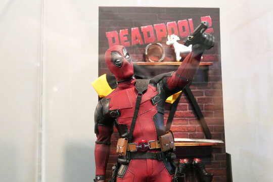 PENANG, MALAYSIA -MARCH 23, 2022: Fiction character of Deadpool from Marvel movies and comic. Deadpool action figure toys displayed by collector for the public. 
