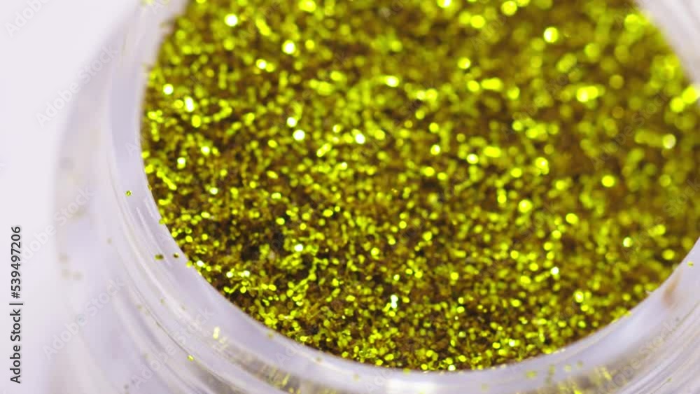 Poster golden sequins in a jar rotate in a circle