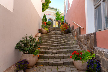 Fototapeta na wymiar Beautiful colorful cityscape of Szentendre with autumn flower pots on a narrow stairway