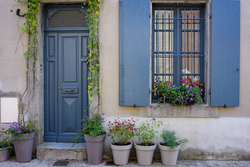 Front view of a facade of a traditional house in an old town of Carcassonne France. Blue shutters...