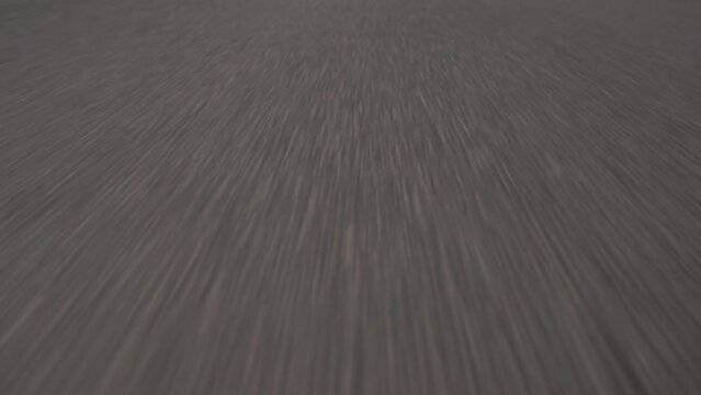 Closeup of asphalt road with fast movement. Fooage. Summer road with white stirpes.