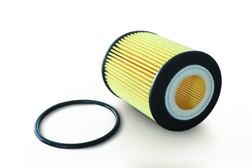 Car engine paper fold filter and black rubber o-ring on white floor