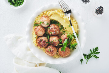 Swedish meatballs in cream sauce, potatoes and lingonberry sauce in bowl on slate, stone or concrete backgrounds. Swedish cuisine. Delicious creamy mashed potatoes. Top view.