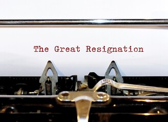 Old classic vintage typewriter with typed text THE GREAT RESIGNATION, a mass voluntary exodus from the workforce - millions workers are quitting their jobs.