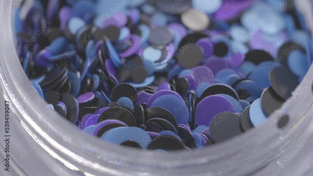 Poster blue sequins in a jar rotate in a circle