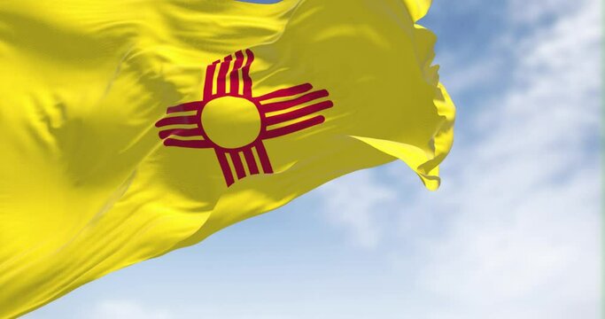 Flag of New Mexico state waving in the wind on a clear day