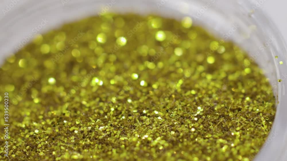 Poster golden sequins in a jar rotate in a circle