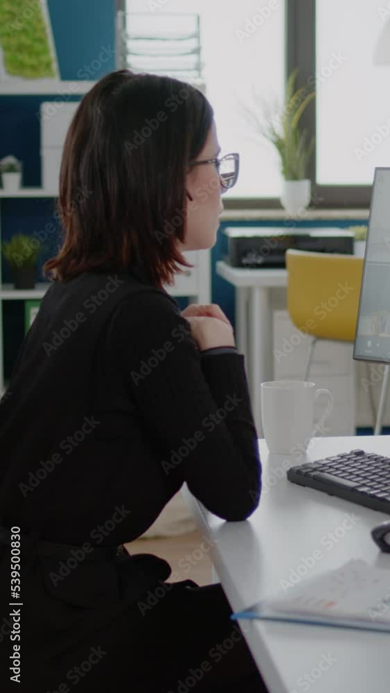 Poster vertical video: businesswoman using video call for meeting with workmates on computer. engineer talk