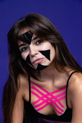 Face taping, beautiful girls face with cosmetological tape. Face aesthetic taping. anti-aging lifting method for reduction of wrinkles. elastic therapeutic tape. Eliminate wrinkles. Skin care. 