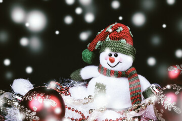 fun toy snowman and Christmas decorations on a black background