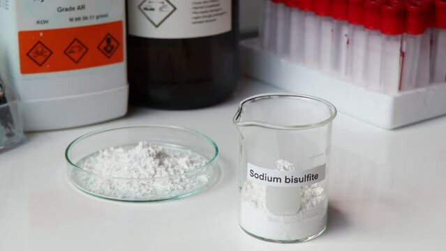 sodium bisulfite powder in glass, chemical in the laboratory and industry