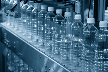 Close up scene of the empty drinking water bottles  on the conveyor belt for filling process.