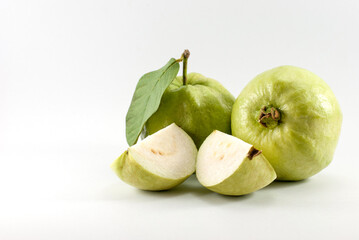 Delicious guava fruit whole and halves piece isolated on a white background, space for text.