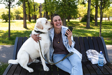 Young woman adopt young dog Labrador Retriever from animal rescue center and gave him love and...