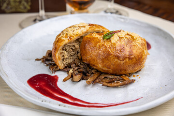 delicious baked meat pie on a wooden table
