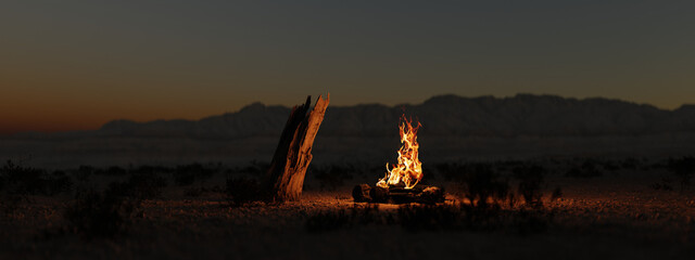 Campfire in the evening in the desert in front of desert mountains
