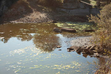 putrid and polluted waters in an abandoned granite stone quarry