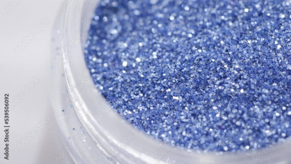 Poster blue sequins in a jar rotate in a circle