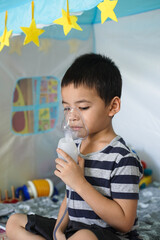 Asian boy wearing oxygen mask