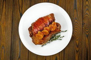 baked meat, pork on a wooden table
