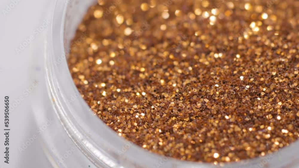Poster golden sequins in a jar rotate in a circle