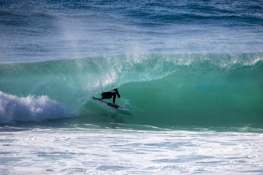 Person Surfing A Wave Tunnel In The Ocean.