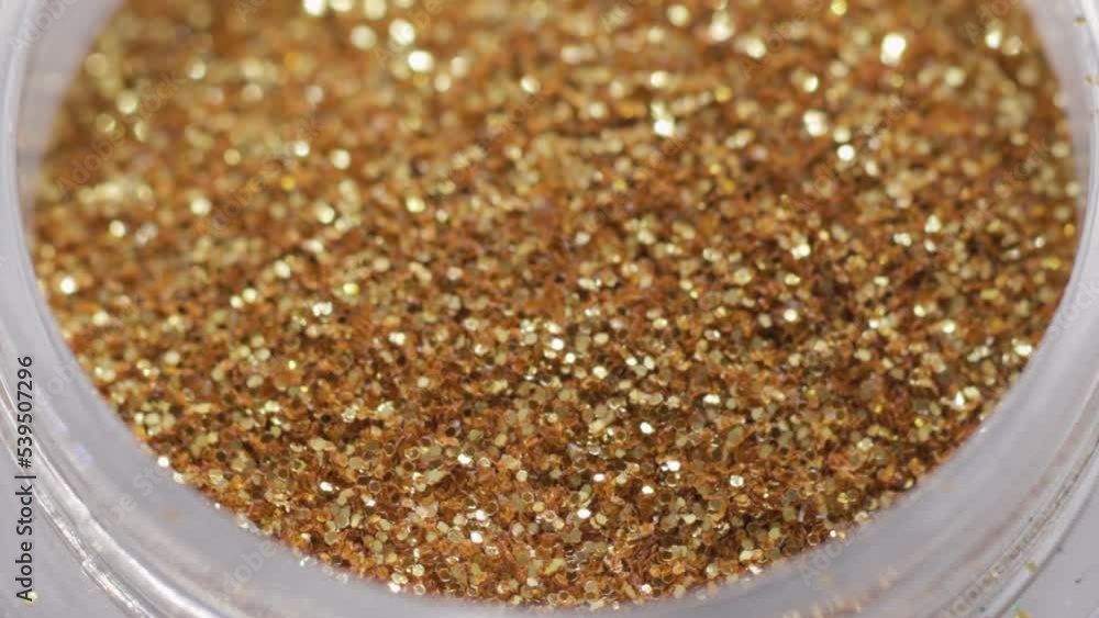 Poster golden sequins in a jar rotate in a circle
