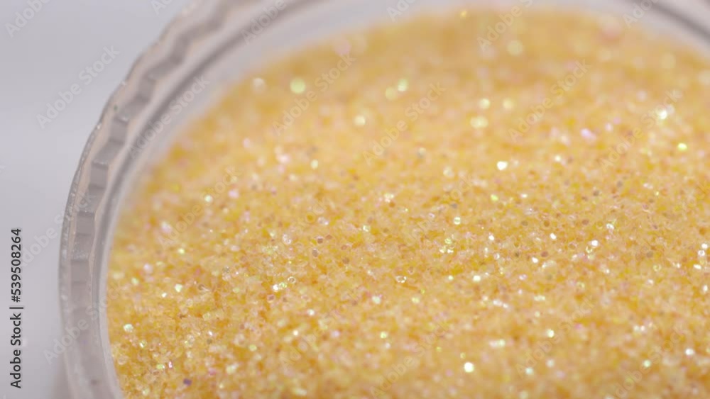 Aufkleber golden sequins in a jar rotate in a circle