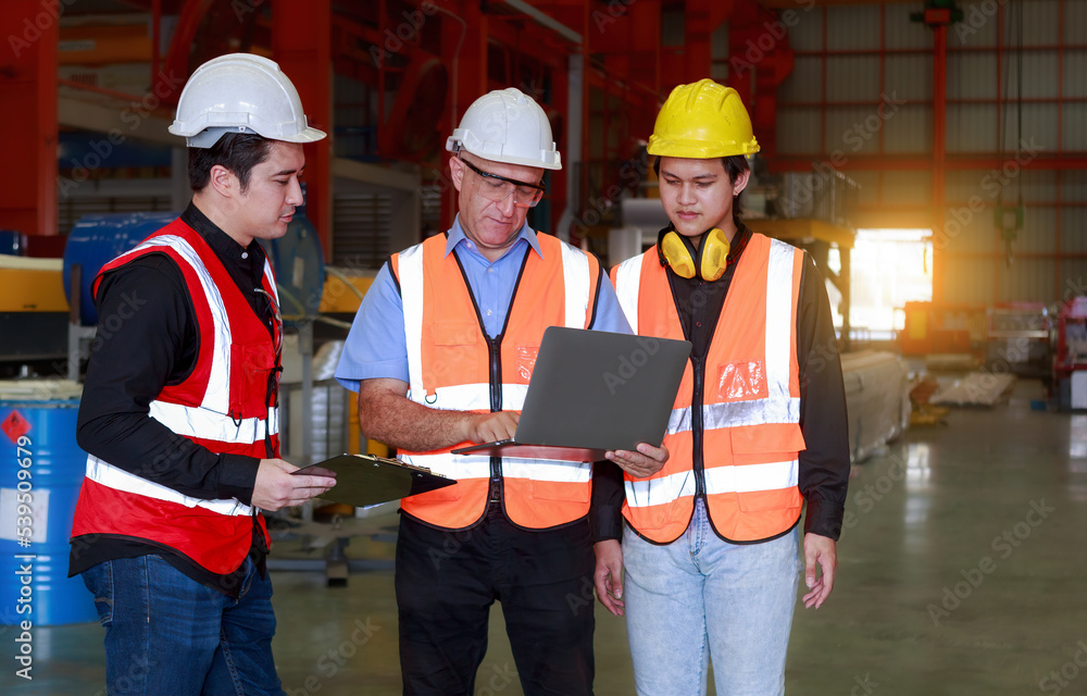 Poster a manager using an empty laptop schematically with a team of multi-ethnic male engineers in safety c