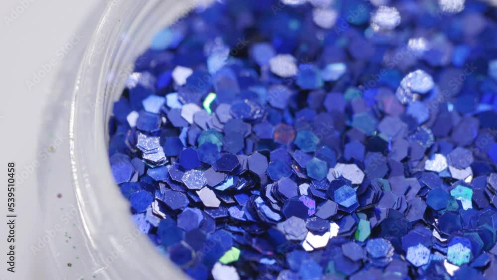 Poster blue sequins in a jar rotate in a circle