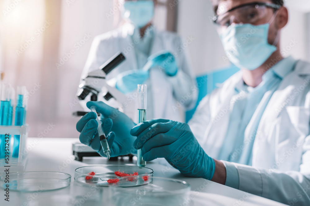 Poster doctor in the laboratory analyzes samples of codiv-9 under a microscope