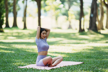 Beautiful young asian woman yoga exercising in the park.