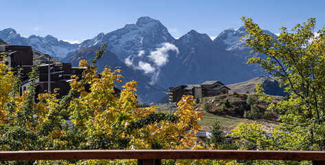Fototapeta na wymiar Indian Summer view in Alpe d'Huez ski resort in the French Alps, France