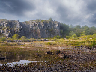 Old abandoned stone quarry. Cloudy sky. Calm and peaceful mood. Nature scenery.