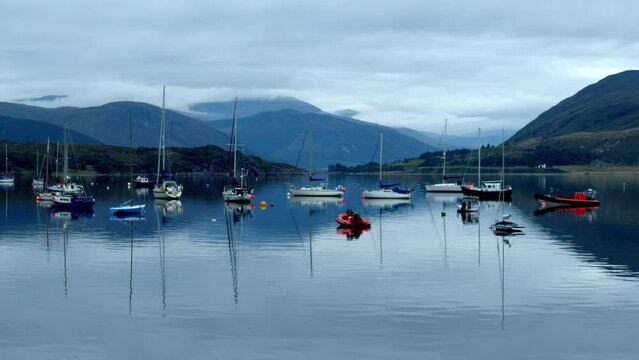 Boats moored in a lake in Ullapool