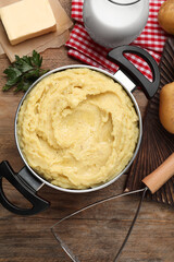 Flat lay composition with tasty mashed potatoes and ingredients on wooden table